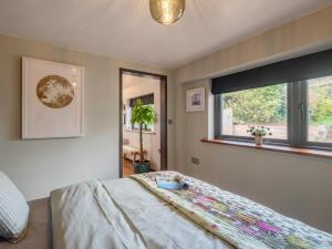 a bedroom with a large bed and a window at 1 Bed in Okehampton oc-78087 in Hatherleigh