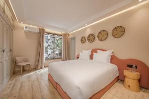 a bedroom with a large white bed and a window at GUELIZ Seven Stays in Marrakesh