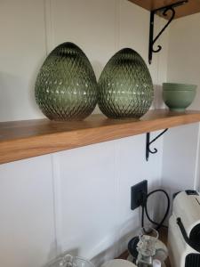 two green baskets sitting on a shelf in a kitchen at Au Coin du Chêne in Thaon-les-Vosges +13 photos
