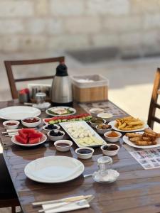 a wooden table with plates of food on it at Balloon Street Cappadocia in Göreme