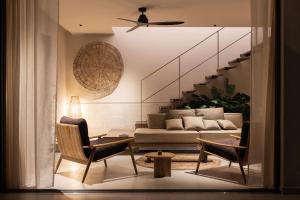 a living room with a couch and a staircase at Terra Mare Villas in Ialysos
