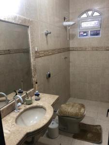 a bathroom with a sink and a toilet at Casa nova 2 quartos in Montes Claros +8 photos