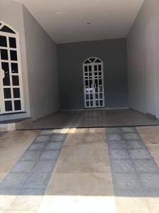 an empty room with a door and a window at Casa nova 2 quartos in Montes Claros