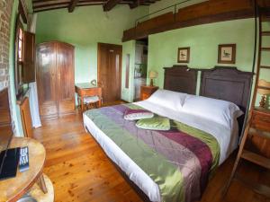 a bedroom with a large bed and a wooden floor at Agriturismo Case Mori in Rimini