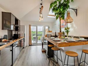 a kitchen with a bar with stools and a counter top at 2 Bed in Barnstaple oc-94038 in Bishops Tawton