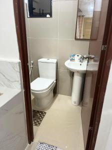 a small bathroom with a toilet and a sink at K and E transient loft house in Puerto Princesa City
