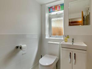 a bathroom with a toilet and a sink and a window at 2 Bed in Barnstaple oc-94038 in Bishops Tawton +8 photos