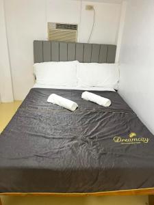 a bed with two white pillows on top of it at K and E transient loft house in Puerto Princesa City