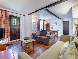 a living room with a couch and a table at 2 Bed in Minehead oc-90924 in Minehead