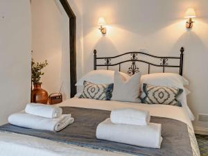 a bedroom with a large bed with towels on it at 2 Bed in Minehead oc-90924 in Minehead +28 photos