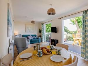 a dining room with a table and a living room at 2 Bed in Taunton oc-96234 in West Quantoxhead