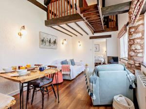 a living room with a table and a bedroom at 2 Bed in Minehead oc-90925 in Minehead