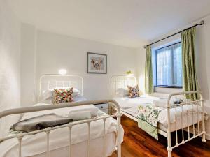 a bedroom with two beds and a window at 2 Bed in Minehead oc-90925 in Minehead
