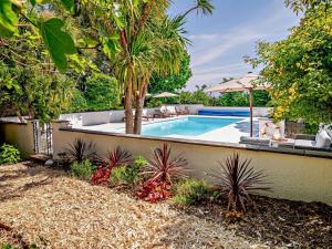 a swimming pool in a yard with trees and plants at 2 Bed in Minehead oc-90925 in Minehead +27 photos