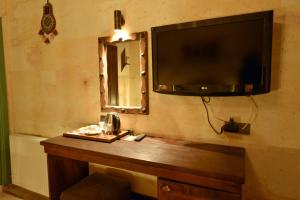 a flat screen tv hanging on a wall with a telephone at Balloon Street Cappadocia in Göreme