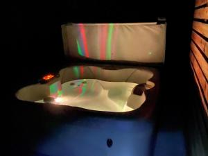 a bathroom with a bathtub with a candle in it at 2 Bed in Okehampton oc-92385 in Okehampton