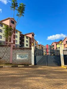 a fence with a sign on it next to some buildings at Kwetuhaven in Kiambu