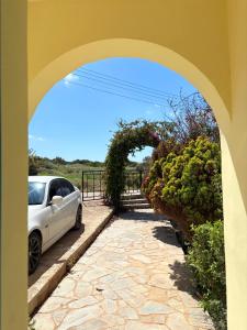 a white car parked next to a stone driveway at Queen Evridiki in Peyia