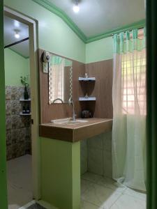 a bathroom with a sink and a mirror at 74YOU Beach Resort and Restaurant in Puerto Princesa City +64 photos