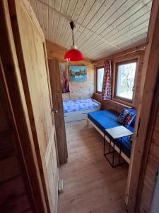 a room with a bed and a table in a cabin at Villa Beata in Nowe Warpno