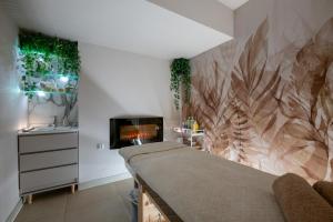 a bedroom with a bed and a fireplace at Kościelna Loft SPA Apartaments in Rybnik