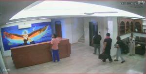 a group of people standing in a room with an art exhibit at The great Garuda hotel in Rishīkesh