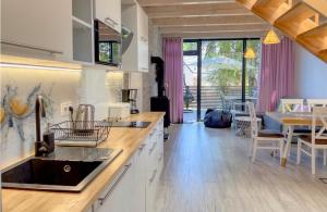 a kitchen with a sink and a dining room at Ulinia Zacisze Dom Comfort 70m2 in Ulinia
