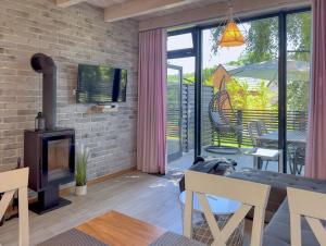 a dog is sitting in a living room with a fireplace at Ulinia Zacisze Dom Comfort 70m2 in Ulinia