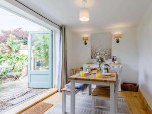a dining room with a table and a large window at 1 Bed in Chulmleigh oc-82389 in Chulmleigh