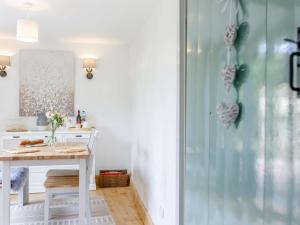 a room with a table and a glass shower at 1 Bed in Chulmleigh oc-82389 in Chulmleigh +7 photos