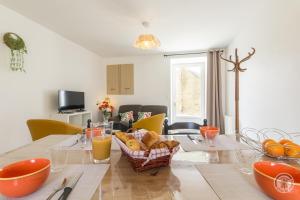 a dining room with a table with food on it at Gîte G1304 in Sottevast