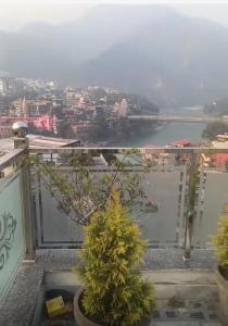 a view of a body of water from a balcony at The great Garuda hotel in Rishīkesh