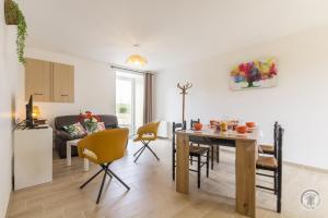 a kitchen and living room with a table and chairs at Gîte G1304 in Sottevast