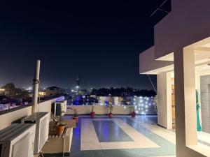 a balcony with a view of a city at night at Hotel Kavita Inn in Ujjain