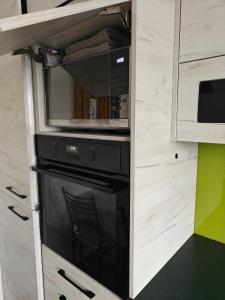 a microwave oven sitting inside of a kitchen at Clonakilty Holiday Home in Clonakilty +8 photos