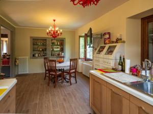 a kitchen with a table and chairs and a dining room at Perbone 1573 - Premium Restored Villa in Toano +22 photos