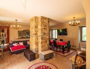 a living room with a large stone pillar at Perbone 1573 - Premium Restored Villa in Toano