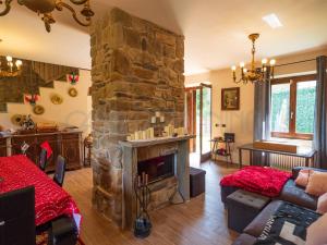 a living room with a large stone fireplace at Perbone 1573 - Premium Restored Villa in Toano