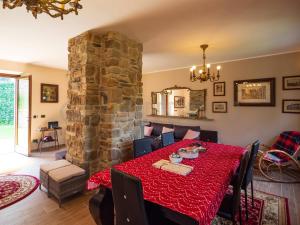 a dining room with a table and a stone pillar at Perbone 1573 - Premium Restored Villa in Toano