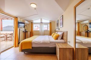 a bedroom with a bed and a mirror at Ten Apart Hotel in Fethiye +33 photos