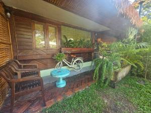 a house with a bench and a bike on the porch at Three Hen Lakeside in Ban Na Nai +23 photos