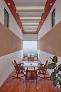 a room with four chairs and a table and a table at Cloud Dale Resort Munnar in Munnar