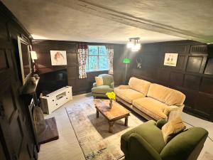 a living room with a couch and a table at Habberley Hall Flat in Shrewsbury