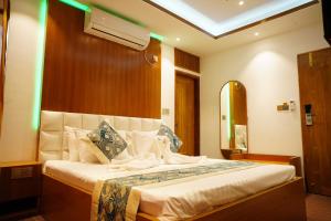 a bedroom with a large bed in a room at Fiona Luxury Resort in Gazipur