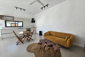 a living room with a couch and a table at Adam Duplex in Cap Malheureux