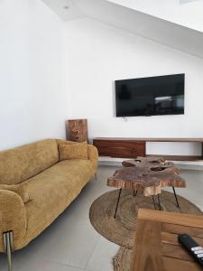 a living room with a couch and a table at Adam Duplex in Cap Malheureux