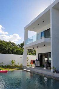 a house with a swimming pool in front of a house at Adam Duplex in Cap Malheureux