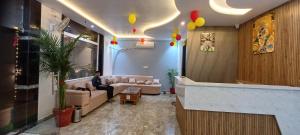 a man sitting on a couch in a living room at Dev Hotel & Restaurant in Vrindāvan +17 photos