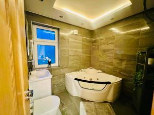 a bathroom with a tub and a toilet and a sink at Arnie in Longley +30 photos