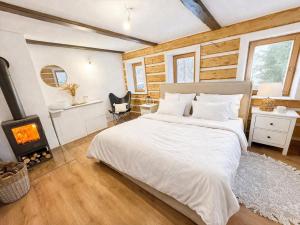 a bedroom with a bed and a fireplace at Kouzelná chalupa u lesa in Krompach